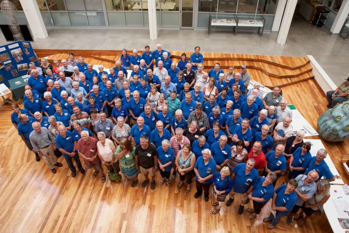 A large group of volunteers pose for the camera